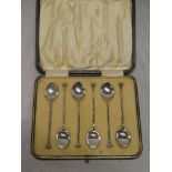 A set of six silver coffee spoons with decorated terminals,