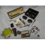 A jewellery box containing a selection of various costume jewellery, cheroot holder,