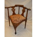 A 19th Century oak corner chair with vase splat back and upholstered seat on scroll legs