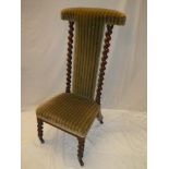 A Victorian mahogany prayer chair upholstered in green striped fabric with spiral twist supports