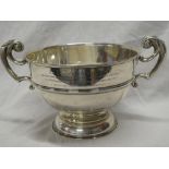 A George V Irish silver circular pedestal two handled rose bowl with engraved inscription 12" high,