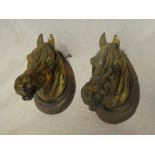 A pair of brass and copper horses head wall plaques 7" high