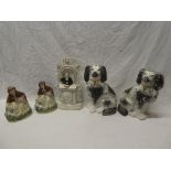 A pair of 19th Century Staffordshire pottery seated spaniel figures with black and white decoration,