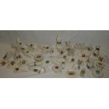 A collection of over thirty-five various military crested souvenir china pieces including British