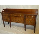 An early to mid-19th Century mahogany break-front sideboard with three drawers in the frieze and