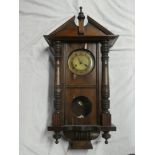A Vienna-style wall clock with decorated circular dial in polished mahogany rectangular case