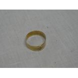 An 18ct gold wedding band with inset diamond chip