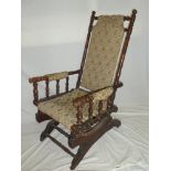 An American beechwood rocking chair with tapestry upholstery on turned supports