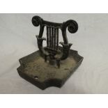 A Victorian cast iron foot scraper with lyre decoration