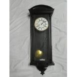 A good quality Vienna-style wall clock with enamelled and brass circular dial in ebonised