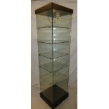 A good quality glass freestanding mobile square section display cabinet with shelves, lock and key,
