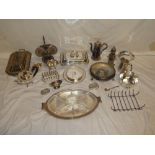 A selection of various electroplated items including entree dishes, three piece tea set, toast rack,