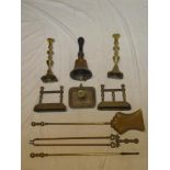 An old brass three piece companion set together with fire dogs,