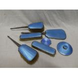 A George V silver and blue enamelled dressing set comprising pair of hairbrushes,