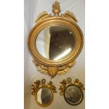 A good quality convex circular wall mirror with gilt leaf decorated frame together with a pair of