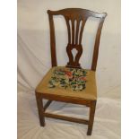 An early 19th Century oak country-style dining chair with pierced vase splat back and tapestry seat