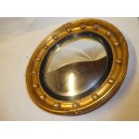 An old convex circular mirror in gilt circular frame decorated with spheres 17" diameter