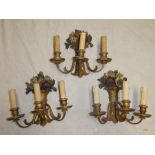 Three modern painted and carved wood three branch wall lights with floral decoration