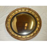 A 19th Century convex circular wall mirror in gilt circular frame decorated with spheres 26"