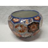 A 19th Century Japanese Imari pottery circular jardiniere with panels decorated with flowers and