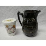 A George V 1911 Coronation beaker and cover and a Victorian 1897 black glazed commemorative jug (2)