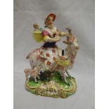 A 19th Century porcelain figure of a female with children riding a goat,