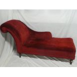 An Edwardian mahogany scroll end chaise longue upholstered in red draylon