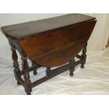 A Charles II oak oval gate leg table with drawer in one end on baluster supports ,