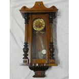 A Vienna-style wall clock with decorated circular dial in polished walnut rectangular case