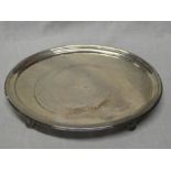 A George III silver oval waiter tray with engraved crest on four tapered feet,