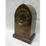 An Edwardian mantel clock with gilt decorated circular dial in inlaid mahogany lancet case