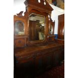 A large Victorian carved walnut sideboard with three drawers in the frieze and cupboard enclosed