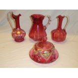 A Victorian cranberry tinted glass ornamental jug with painted decoration,