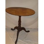 A Victorian mahogany oval occasional table on turned column with tripod base
