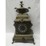 A large 19th Century French brass mantel clock with circular dial and individual porcelain numerals,