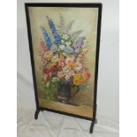 An old stained wood rectangular fire screen with inset oil painting of mixed flowers in a jug by R