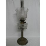 A late Victorian brass oil lamp with fluted column and clear glass reservoir with etched glass