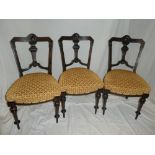 A set of six Victorian ebonised and walnut inlaid dining chairs with vase splat backs and