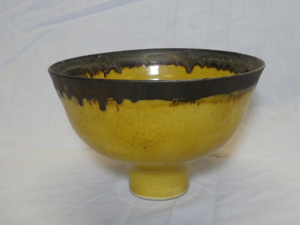 A rare Studio pottery circular pedestal bowl by Lucie Rie with oxidised bronze and yellow glazed