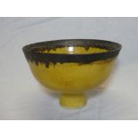A rare Studio pottery circular pedestal bowl by Lucie Rie with oxidised bronze and yellow glazed