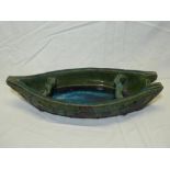A Studio pottery bowl in the form of a rowing boat with green and purple glazed decoration,
