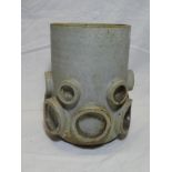 A Studio pottery cylindrical vase with raised circle decoration ,