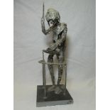 A metal figure of a music conductor on slate base,