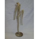 A modern stringwork figure of a dancer,