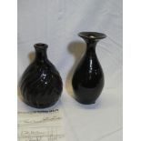 A black glazed Studio pottery baluster-shaped vase, unmarked,