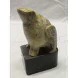 A polished soapstone/marble figure a seated frog on black marble base,