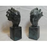 A pair of modern bronze figures of heads on rectangular plinths,