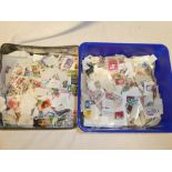 A tin of World stamps off paper and a tin of GB commemorative stamps off paper (2)