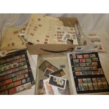 A box containing various stock cards and album pages of mixed World stamps including USA,