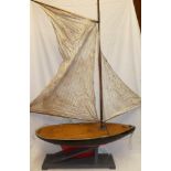 An old wooden model pond yacht, 29" long with mast,